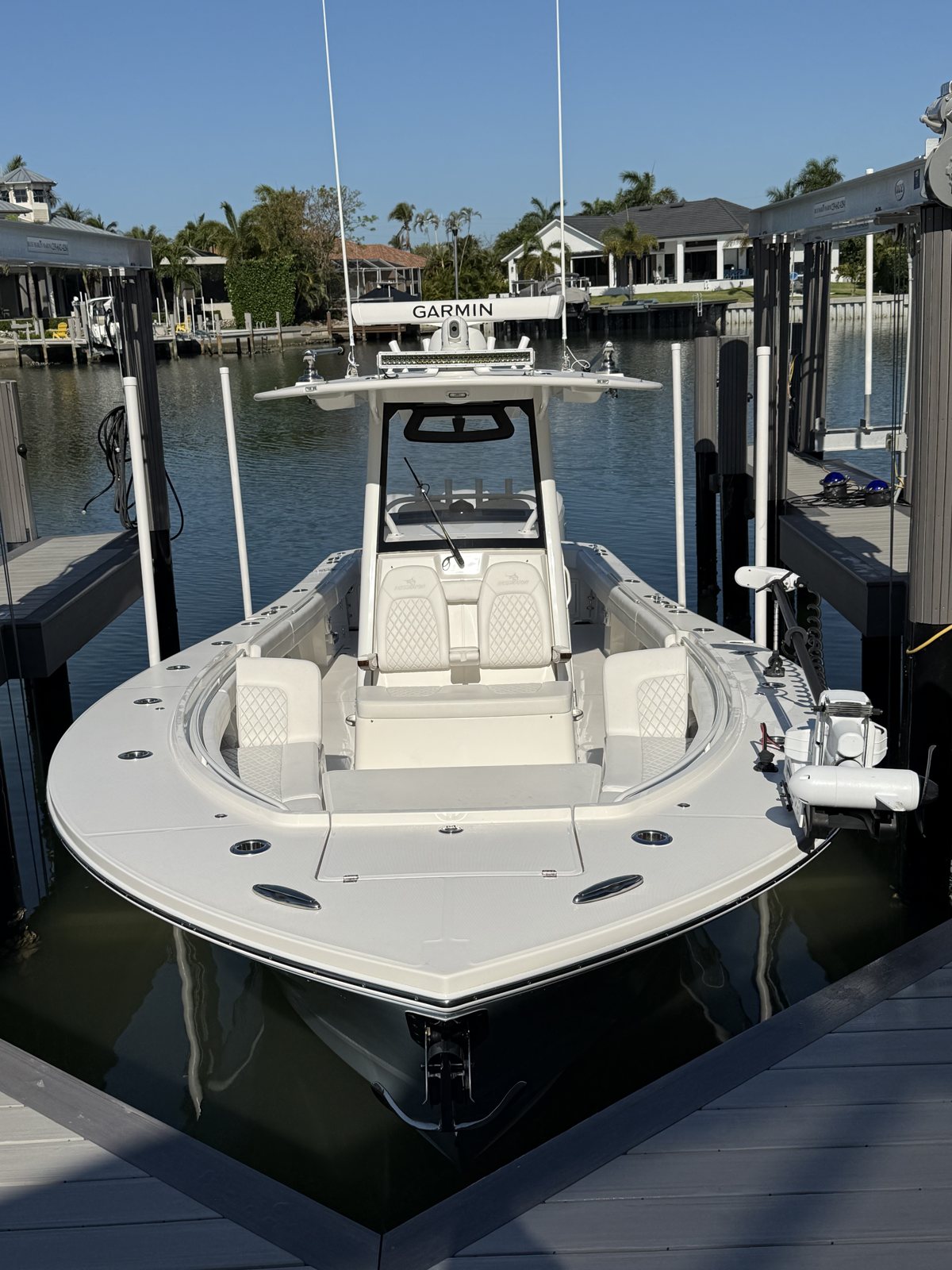 Center console boat docked at a private dock, ready for mobile service
