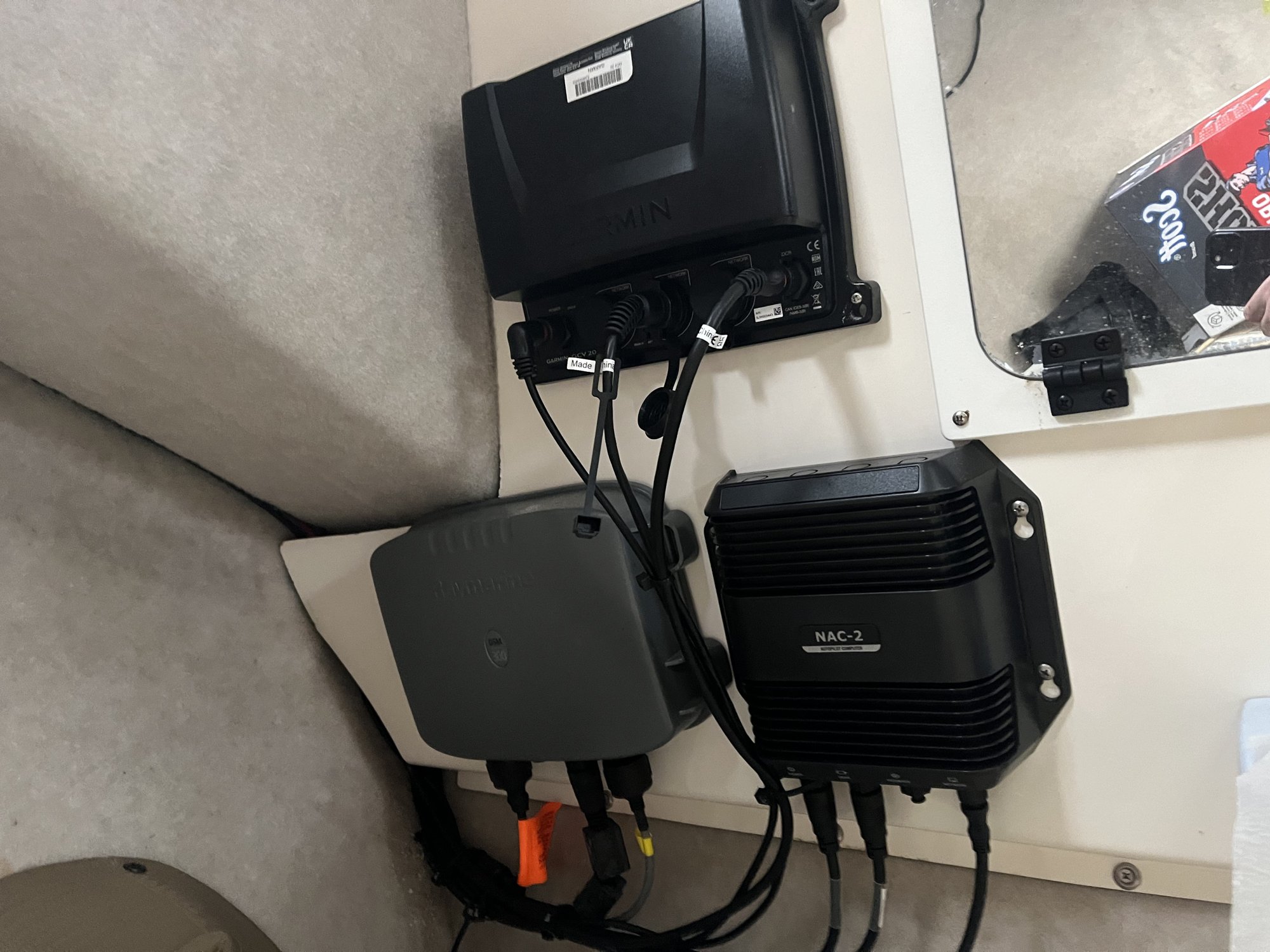 Electronics and autopilot installation with neatly labeled wiring behind the helm