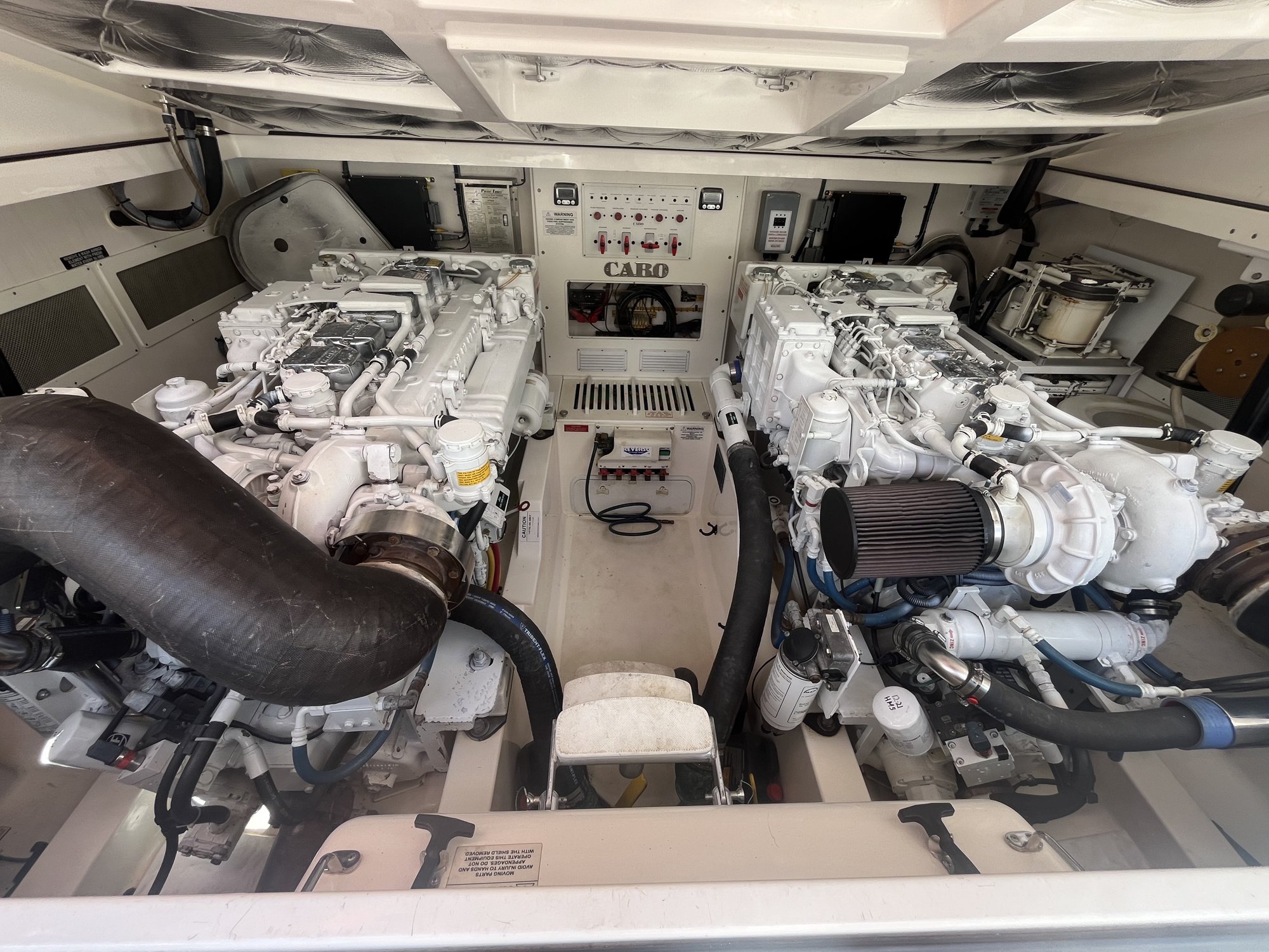 Spotless twin-diesel engine room aboard a CABO sportfisher