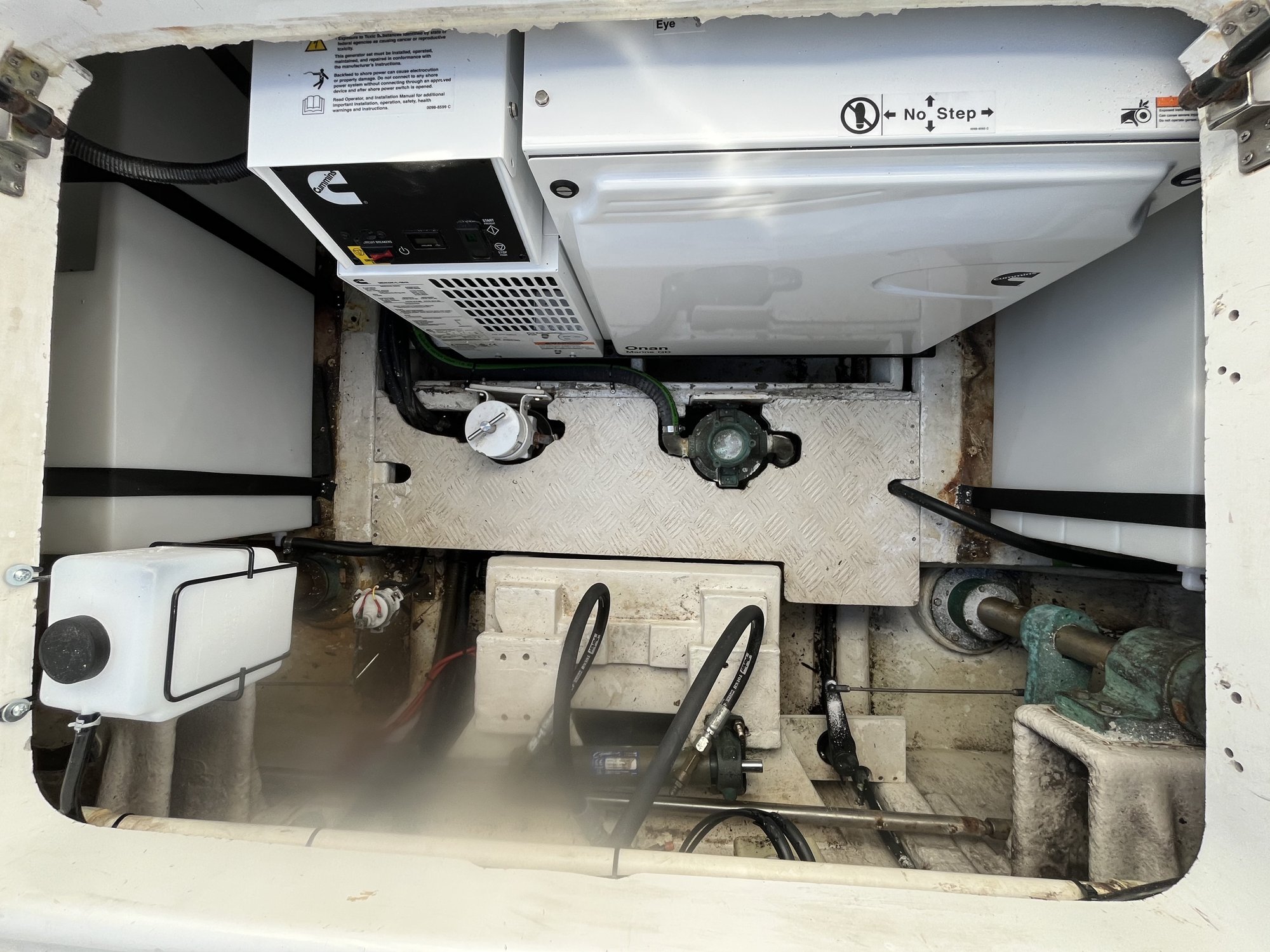 Onan marine generator during service between the fuel tanks