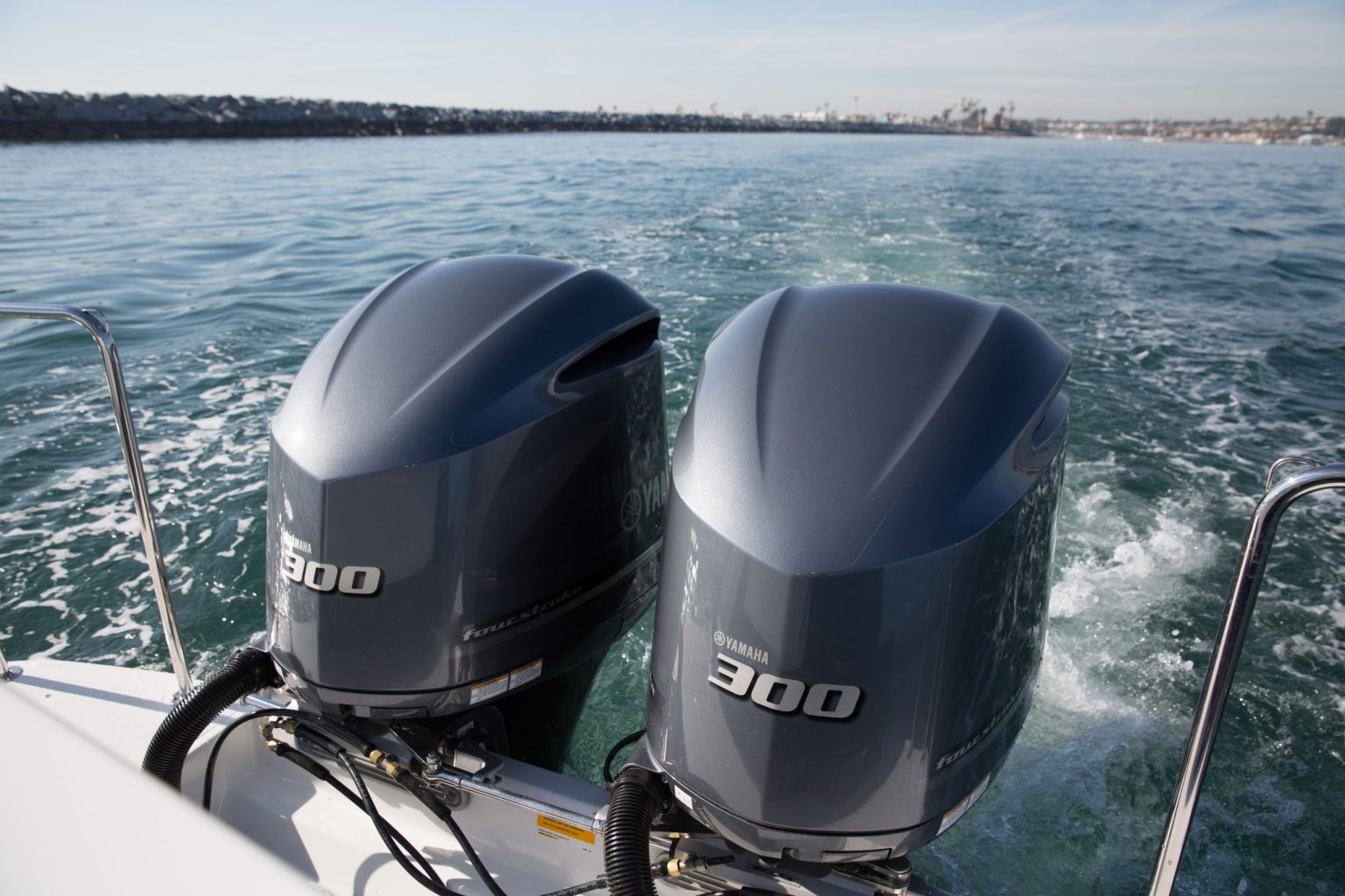 Twin Yamaha 300 four-stroke outboard motors on the stern of a boat on open water